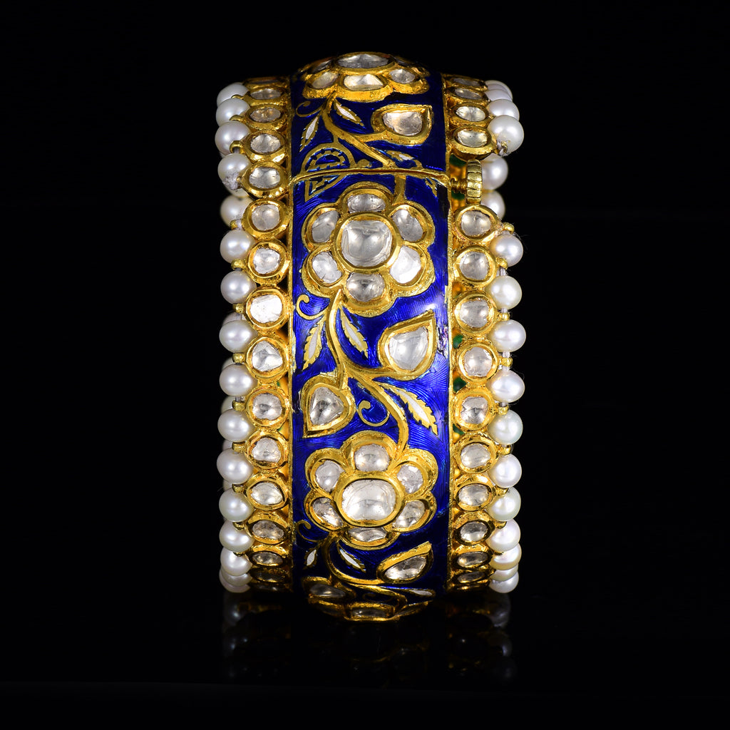 Blue meena broad kada in 22k gold with uncut diamond The broad size of the kada ensures that it fits comfortably on most wrist sizes and the sturdy construction makes it a durable piece of jewelry that can be treasured for years to come.  - KMB0485